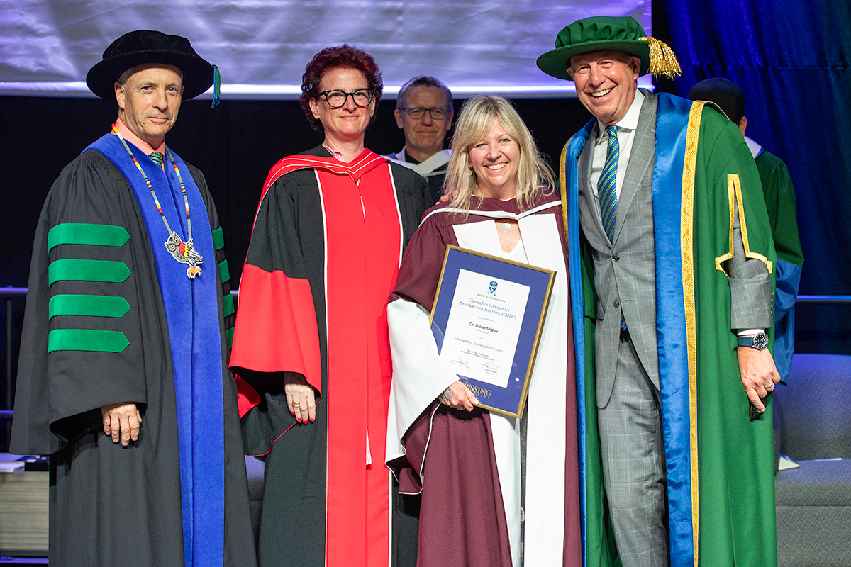 Susan Srigley with award on stage