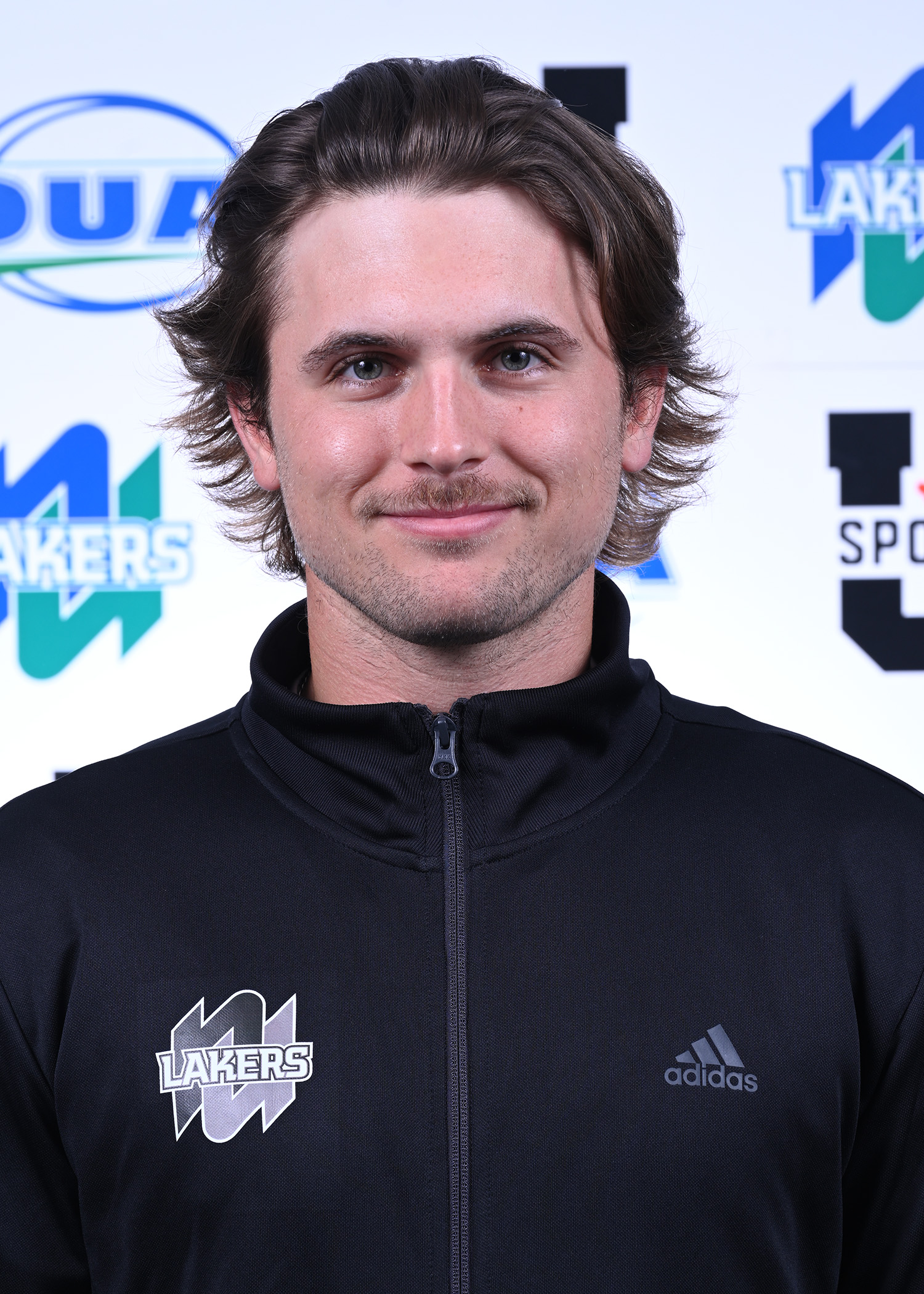 Jonathan Reese smiling into the camera with a Lakers backdrop