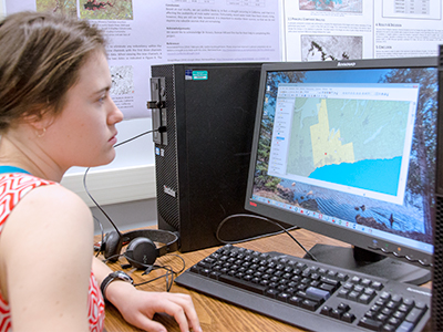 student on a computer in the geomatics lab