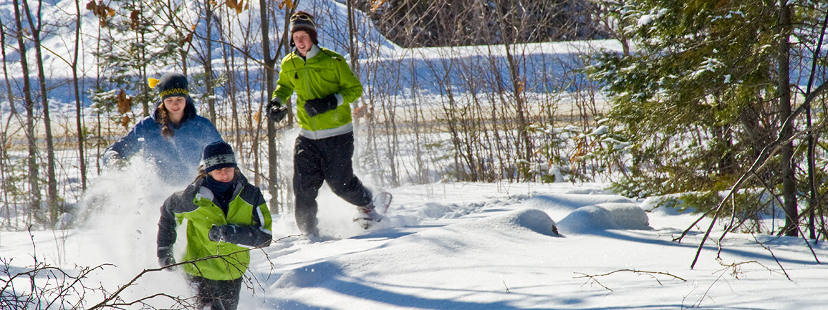 student running in the snow in snowshoes 