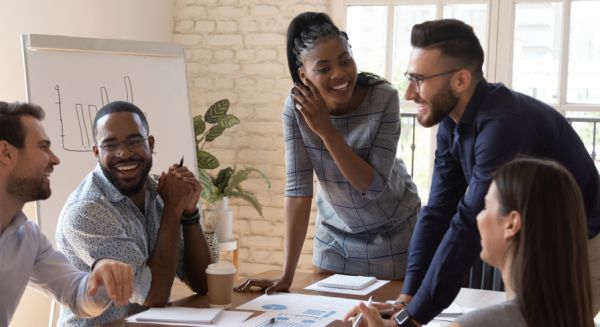 A group of coworkers laughing and having a discussion