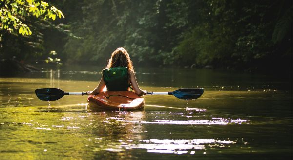 a girl paddling in the La Vase River