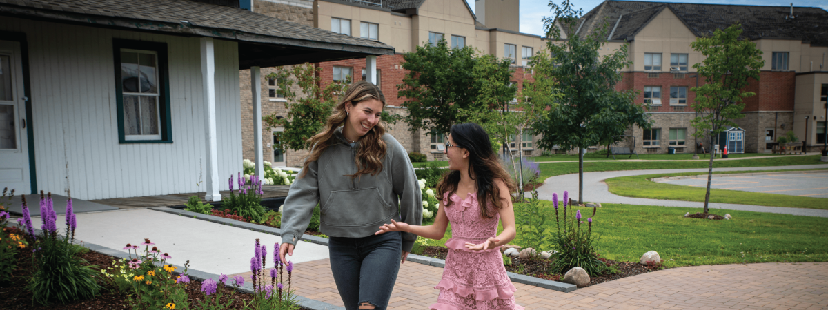 2 students talking in front of Dionne Quints Museum