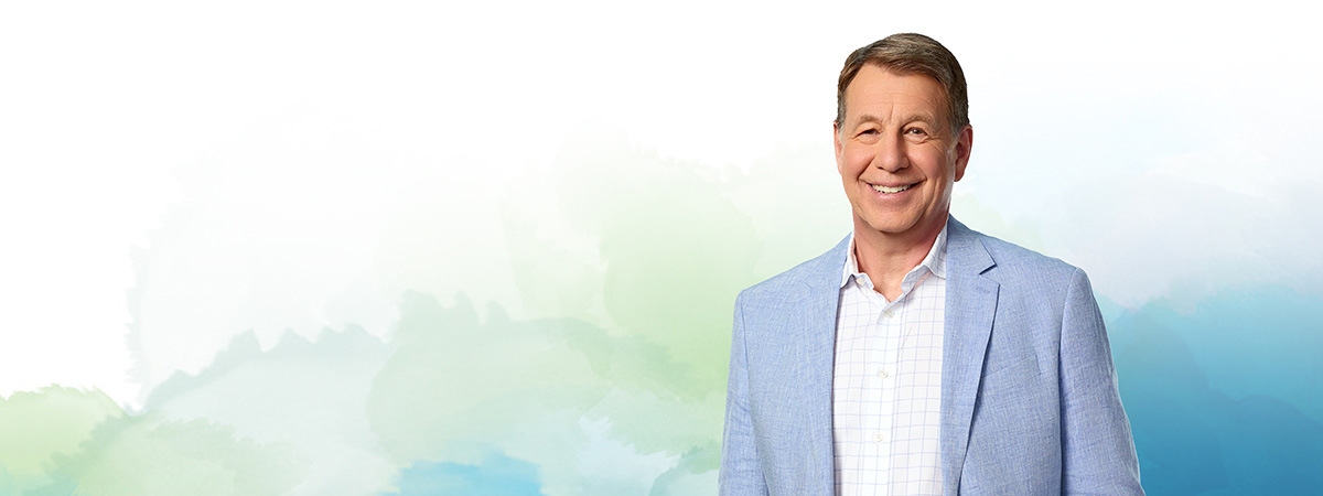 Scott Russell with Nipissing University watercolour branding in the background