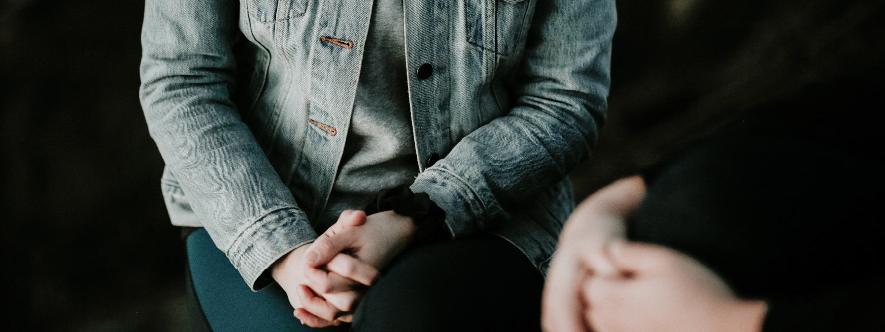 Student with hands clasped in lap