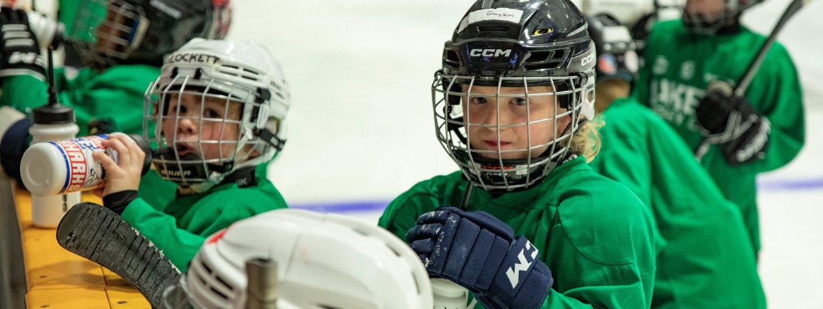 youth in hockey gear at rink