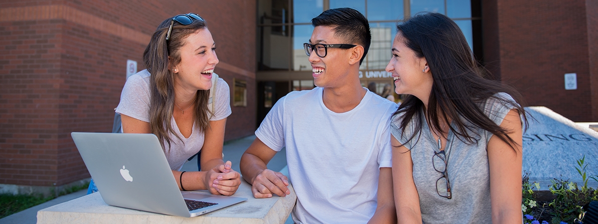 Students sitting in front of Nipissing University