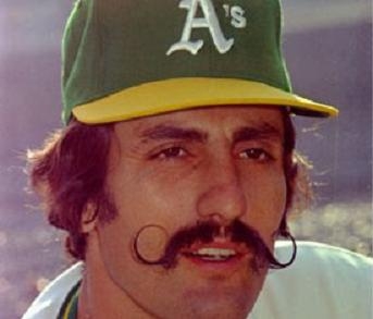 Photo of a man in an Oakland A's hat and a giant handlebar moustache