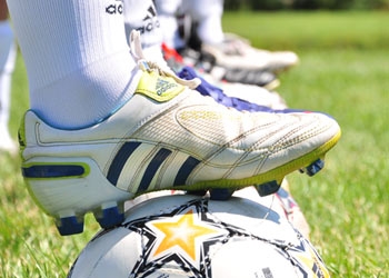Photo of soccer cleat on soccer ball