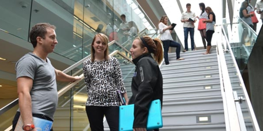 students talking in the library