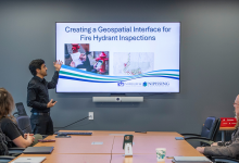 Keshav Singh, Lovepreet Kaur, and Sagar Tewatia presenting their GIS projects in the CIty Hall Executive Boardroom