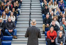 Dr. Kevin Wamsley addresses the packed bleachers in front of him, filled with guests attending the Fall Open House event.
