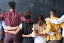 back facing group shot of everyone with their arm's around each other