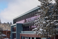 A snowy photo of the campus library and the nature that surrounds it.