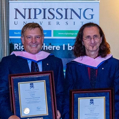 Alex Lifeson and Geddy Lee with degrees